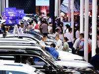 People look at various vehicles at the 23rd Autumn International Auto Show in Qingdao, China, on September 5, 2024. (