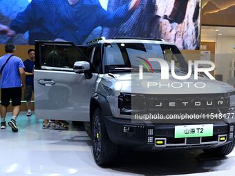 People look at various vehicles at the 23rd Autumn International Auto Show in Qingdao, China, on September 5, 2024. (