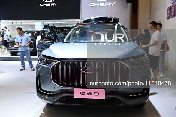 People look at various vehicles at the 23rd Autumn International Auto Show in Qingdao, China, on September 5, 2024. 