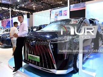 People look at various vehicles at the 23rd Autumn International Auto Show in Qingdao, China, on September 5, 2024. (