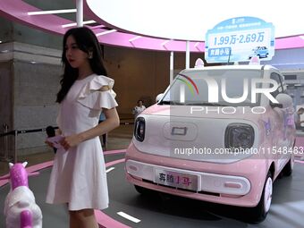 People look at various vehicles at the 23rd Autumn International Auto Show in Qingdao, China, on September 5, 2024. (