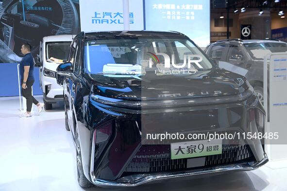 People look at various vehicles at the 23rd Autumn International Auto Show in Qingdao, China, on September 5, 2024. 