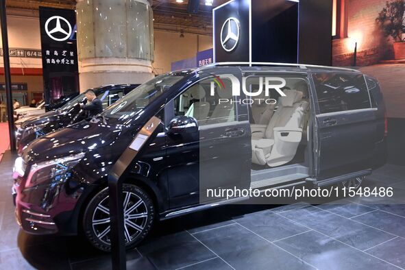 People look at various vehicles at the 23rd Autumn International Auto Show in Qingdao, China, on September 5, 2024. 