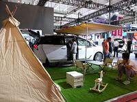 People look at various vehicles at the 23rd Autumn International Auto Show in Qingdao, China, on September 5, 2024. (