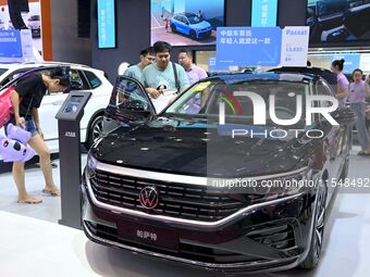 People look at various vehicles at the 23rd Autumn International Auto Show in Qingdao, China, on September 5, 2024. (