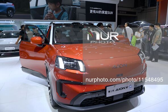 People look at various vehicles at the 23rd Autumn International Auto Show in Qingdao, China, on September 5, 2024. 