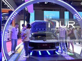 People look at various vehicles at the 23rd Autumn International Auto Show in Qingdao, China, on September 5, 2024. (