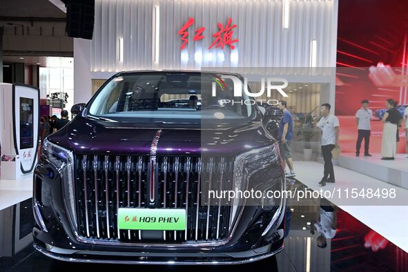 People look at various vehicles at the 23rd Autumn International Auto Show in Qingdao, China, on September 5, 2024. 