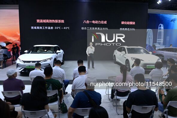 People look at various vehicles at the 23rd Autumn International Auto Show in Qingdao, China, on September 5, 2024. 