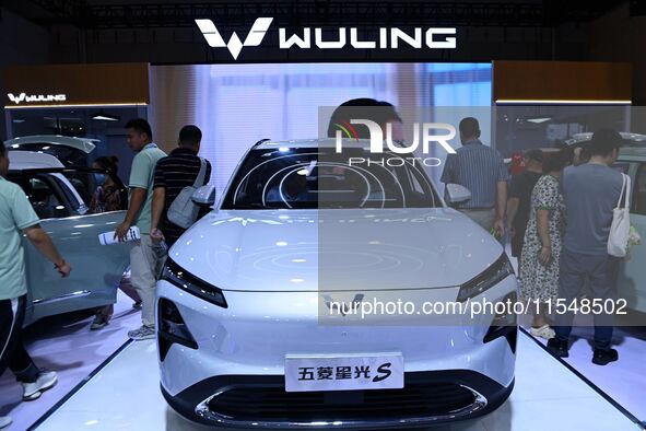 People look at various vehicles at the 23rd Autumn International Auto Show in Qingdao, China, on September 5, 2024. 