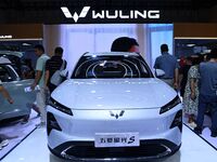 People look at various vehicles at the 23rd Autumn International Auto Show in Qingdao, China, on September 5, 2024. (