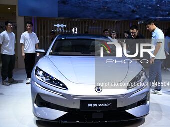 People look at various vehicles at the 23rd Autumn International Auto Show in Qingdao, China, on September 5, 2024. (