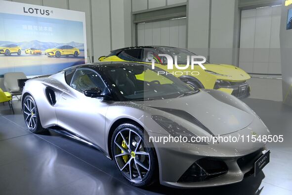 People look at various vehicles at the 23rd Autumn International Auto Show in Qingdao, China, on September 5, 2024. 