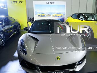 People look at various vehicles at the 23rd Autumn International Auto Show in Qingdao, China, on September 5, 2024. (