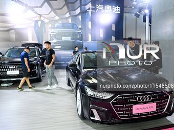 People look at various vehicles at the 23rd Autumn International Auto Show in Qingdao, China, on September 5, 2024. (