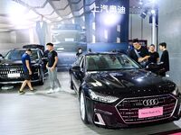 People look at various vehicles at the 23rd Autumn International Auto Show in Qingdao, China, on September 5, 2024. (