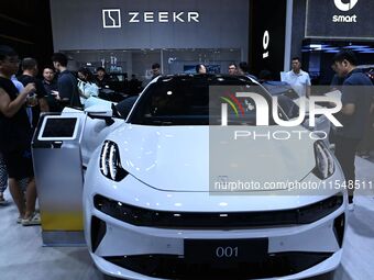 People look at various vehicles at the 23rd Autumn International Auto Show in Qingdao, China, on September 5, 2024. (