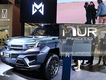 People look at various vehicles at the 23rd Autumn International Auto Show in Qingdao, China, on September 5, 2024. (