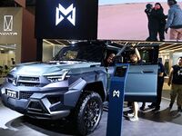 People look at various vehicles at the 23rd Autumn International Auto Show in Qingdao, China, on September 5, 2024. (