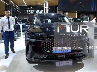 People look at various vehicles at the 23rd Autumn International Auto Show in Qingdao, China, on September 5, 2024. (