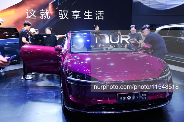 People look at various vehicles at the 23rd Autumn International Auto Show in Qingdao, China, on September 5, 2024. 