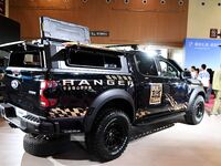 People look at various vehicles at the 23rd Autumn International Auto Show in Qingdao, China, on September 5, 2024. (