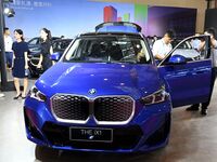 People look at various vehicles at the 23rd Autumn International Auto Show in Qingdao, China, on September 5, 2024. (