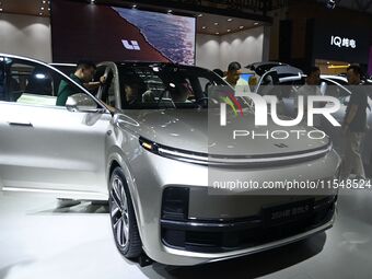 People look at various vehicles at the 23rd Autumn International Auto Show in Qingdao, China, on September 5, 2024. (