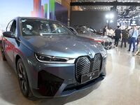 People look at various vehicles at the 23rd Autumn International Auto Show in Qingdao, China, on September 5, 2024. (