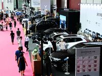 People look at various vehicles at the 23rd Autumn International Auto Show in Qingdao, China, on September 5, 2024. (