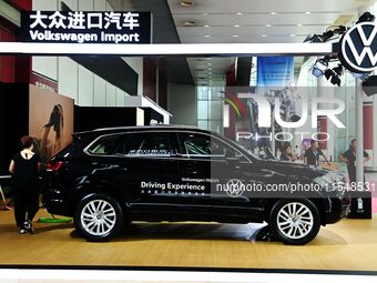 People look at various vehicles at the 23rd Autumn International Auto Show in Qingdao, China, on September 5, 2024. (