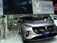 People look at various vehicles at the 23rd Autumn International Auto Show in Qingdao, China, on September 5, 2024. (