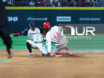 Aristides Aquino #56 of Diablos Rojos slides to avoid the tag by second baseman Ramiro Pena #19 of Sultanes de Monterrey during the match 1...