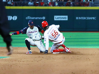 Aristides Aquino #56 of Diablos Rojos slides to avoid the tag by second baseman Ramiro Pena #19 of Sultanes de Monterrey during the match 1...