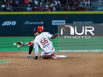 Aristides Aquino #56 of Diablos Rojos slides to avoid the tag by second baseman Ramiro Pena #19 of Sultanes de Monterrey during the match 1...