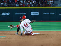 Aristides Aquino #56 of Diablos Rojos slides to avoid the tag by second baseman Ramiro Pena #19 of Sultanes de Monterrey during the match 1...