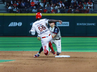 Aristides Aquino #56 of Diablos Rojos slides to avoid the tag by second baseman Ramiro Pena #19 of Sultanes de Monterrey during the match 1...