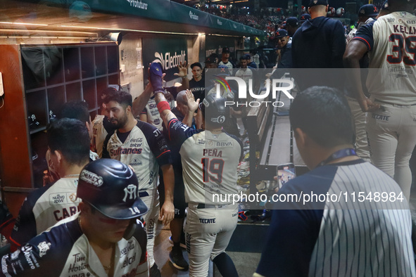 Ramiro Pena #19 of Sultanes de Monterrey celebrates after his run score at the dugout during match 1 against Diablos Rojos of the Mexican Ba...