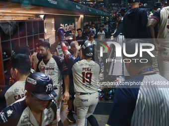 Ramiro Pena #19 of Sultanes de Monterrey celebrates after his run score at the dugout during match 1 against Diablos Rojos of the Mexican Ba...