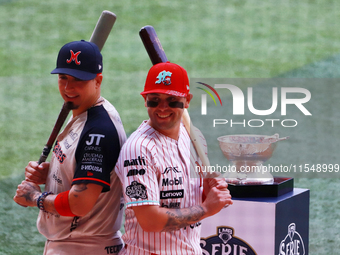 Ramiro Pena #1 of Sultanes de Monterrey and Juan Carlos Gamboa #47 of Diablos Rojos pose with the Zaachila trophy before match 1 of the Mexi...