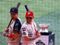 Ramiro Pena #1 of Sultanes de Monterrey and Juan Carlos Gamboa #47 of Diablos Rojos pose with the Zaachila trophy before match 1 of the Mexi...