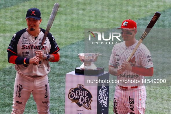 Ramiro Pena #1 of Sultanes de Monterrey and Juan Carlos Gamboa #47 of Diablos Rojos pose with the Zaachila trophy before match 1 of the Mexi...