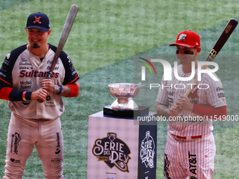 Ramiro Pena #1 of Sultanes de Monterrey and Juan Carlos Gamboa #47 of Diablos Rojos pose with the Zaachila trophy before match 1 of the Mexi...