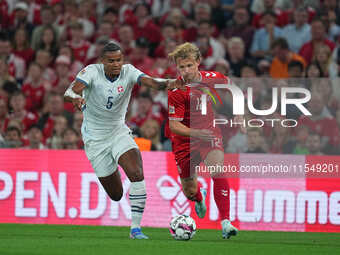 Kasper Dolberg of Denmark and Manuel Akanji of Switzerland battle for the ball during the UEFA Nations League 2024/2025 League A - Group 4 m...