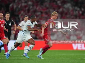 Kasper Dolberg of Denmark and Manuel Akanji of Switzerland battle for the ball during the UEFA Nations League 2024/2025 League A - Group 4 m...