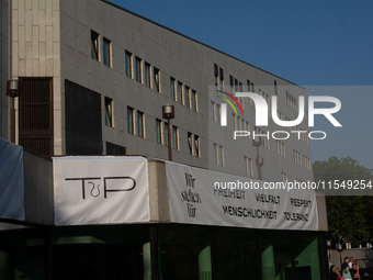 A banner reading ''Freedom, diversity and respect, human rights and tolerance'' hangs on the other buildings of Essen Philharmonie as thousa...