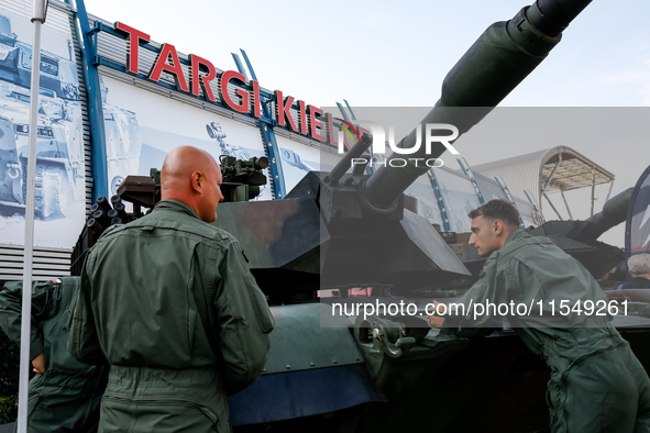 Servicemen stand by Abrams tank as they attends the 32nd International Defence Industry Exhibition - MSPO i Targi Kielce in central Poland o...