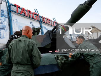 Servicemen stand by Abrams tank as they attends the 32nd International Defence Industry Exhibition - MSPO i Targi Kielce in central Poland o...