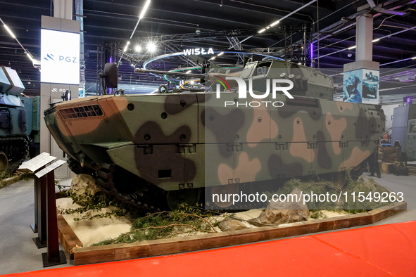 Visitors look at exhibitions of Polish Armaments Group (PGZ) as they attend the 32nd International Defence Industry Exhibition - MSPO i Targ...