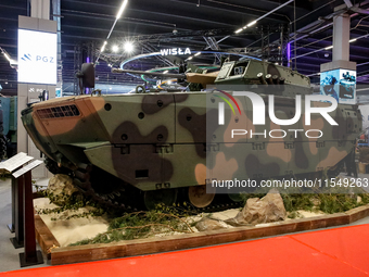 Visitors look at exhibitions of Polish Armaments Group (PGZ) as they attend the 32nd International Defence Industry Exhibition - MSPO i Targ...